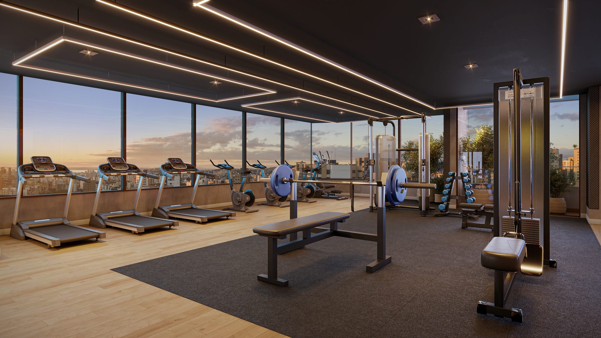 Academia envidraçada com vista para a cidade ao entardecer